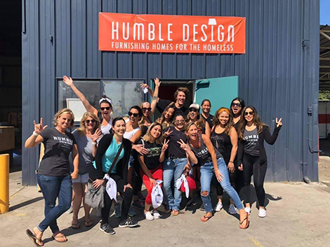 A team of DI and Humble Design volunteers pose in from of the Humble Design warehouse